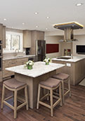 After renovation, new kitchen with two islands, glass wall at floor transition to sunken living room with new fireplace