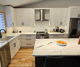 Renovated space with wall between kitchen and dining room removed. New cabinets in white and stained alder