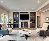 Fireplace after renovation with new cabinets, fireplace box and stone