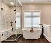 Full height glass steam shower surround with tilting vent and stunning freestanding tub