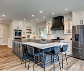 After renovation, kitchen covers much larger space with a large island plus seating