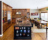 New kitchen with natural walnut perimeter and black island with granite countertops 